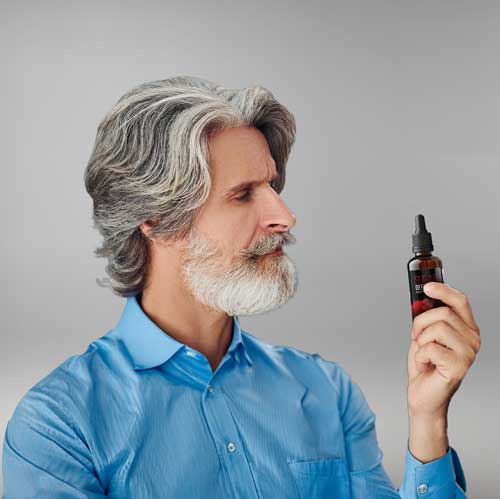 Image of man looking at Bottle of Sugar Defender